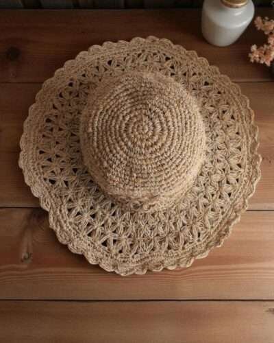 Beige Nest Crochet Hat placed on a wooden table
