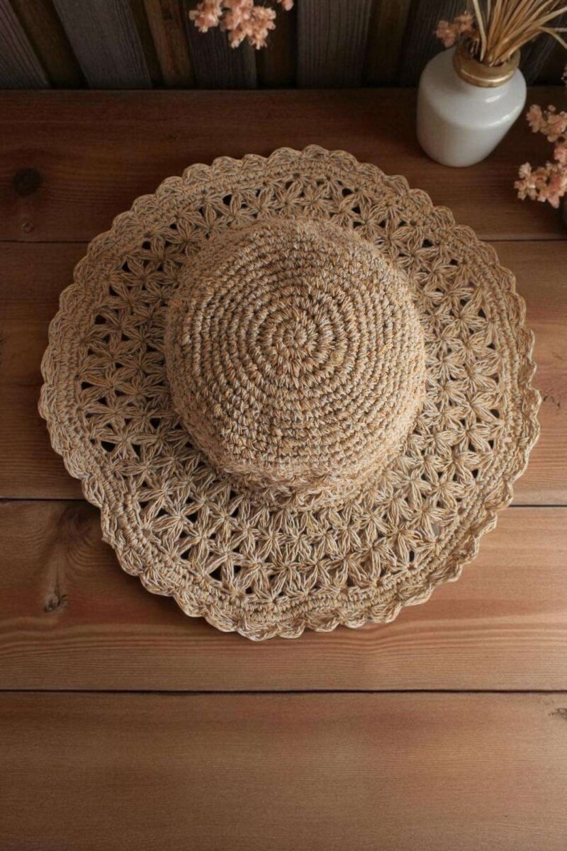 Beige Nest Crochet Hat placed on a wooden table