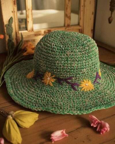 Kumari Crochet Hat Green displayed on the table