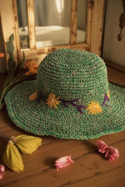 Kumari Crochet Hat Green displayed on the table