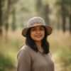 A woman wearing hemp rainbow bordered crochet hat