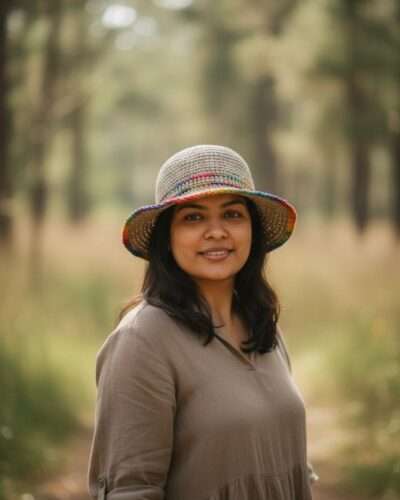 A woman wearing hemp rainbow bordered crochet hat