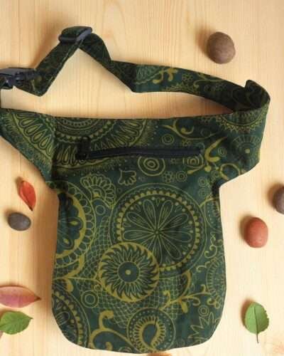 Green Cotton Bum Bag laid flat on a wooden surface
