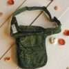 Green Cotton Bum Bag laid flat on a wooden surface