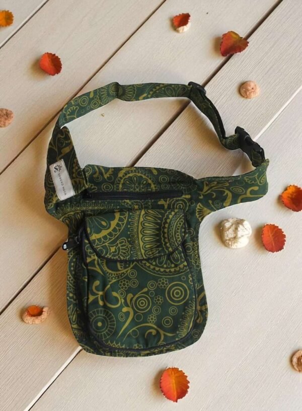Green Cotton Bum Bag laid flat on a wooden surface