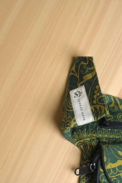 Green Cotton Bum Bag laid flat on a wooden surface