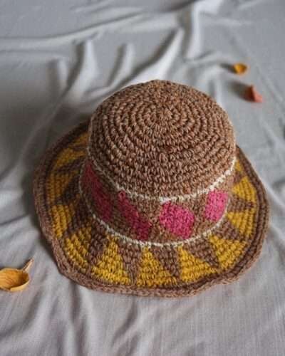 hemp hat laid flat on a white cloth top view