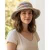 A woman wearing hemp crochet hat in outdoor setting