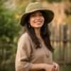 a woman wearing hemp crochet hat in natural setting