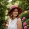 a woman wearing solid pink crochet hat and posing