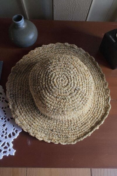 Textured Border Beige Crochet Hat – top view of handmade hemp hat on table