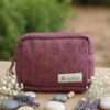 Aubergine color hemp travel pouch on a table front