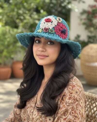 a woman wearing floral embroidery blue hat