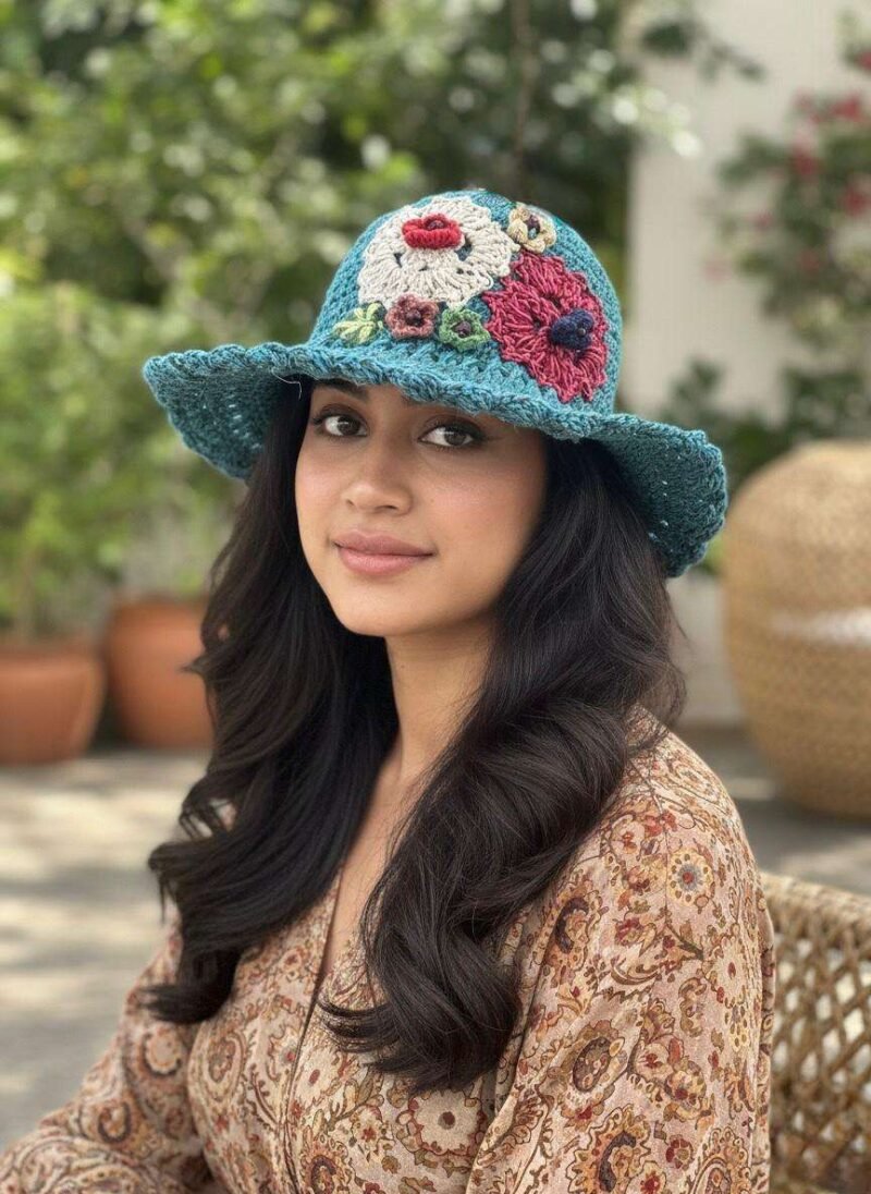 a woman wearing floral embroidery blue hat