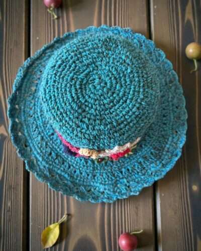 floral embroidery blue hat on table