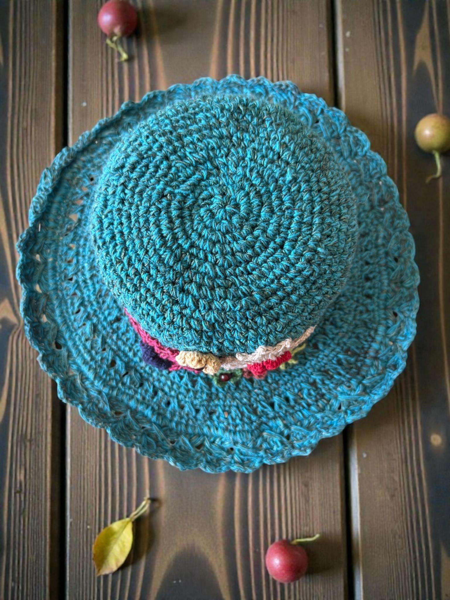 floral embroidery blue hat on table