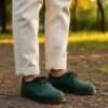 Handmade hemp shoes with laces, eco-friendly vegan footwear from Nepal, natural dye, only legs visible in frame.