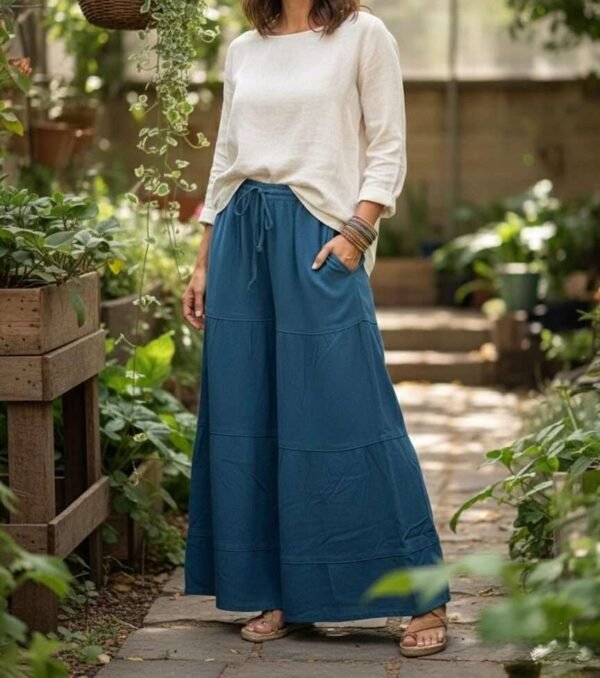 a model wearing teal cotton wide leg trousers in outdoor setting