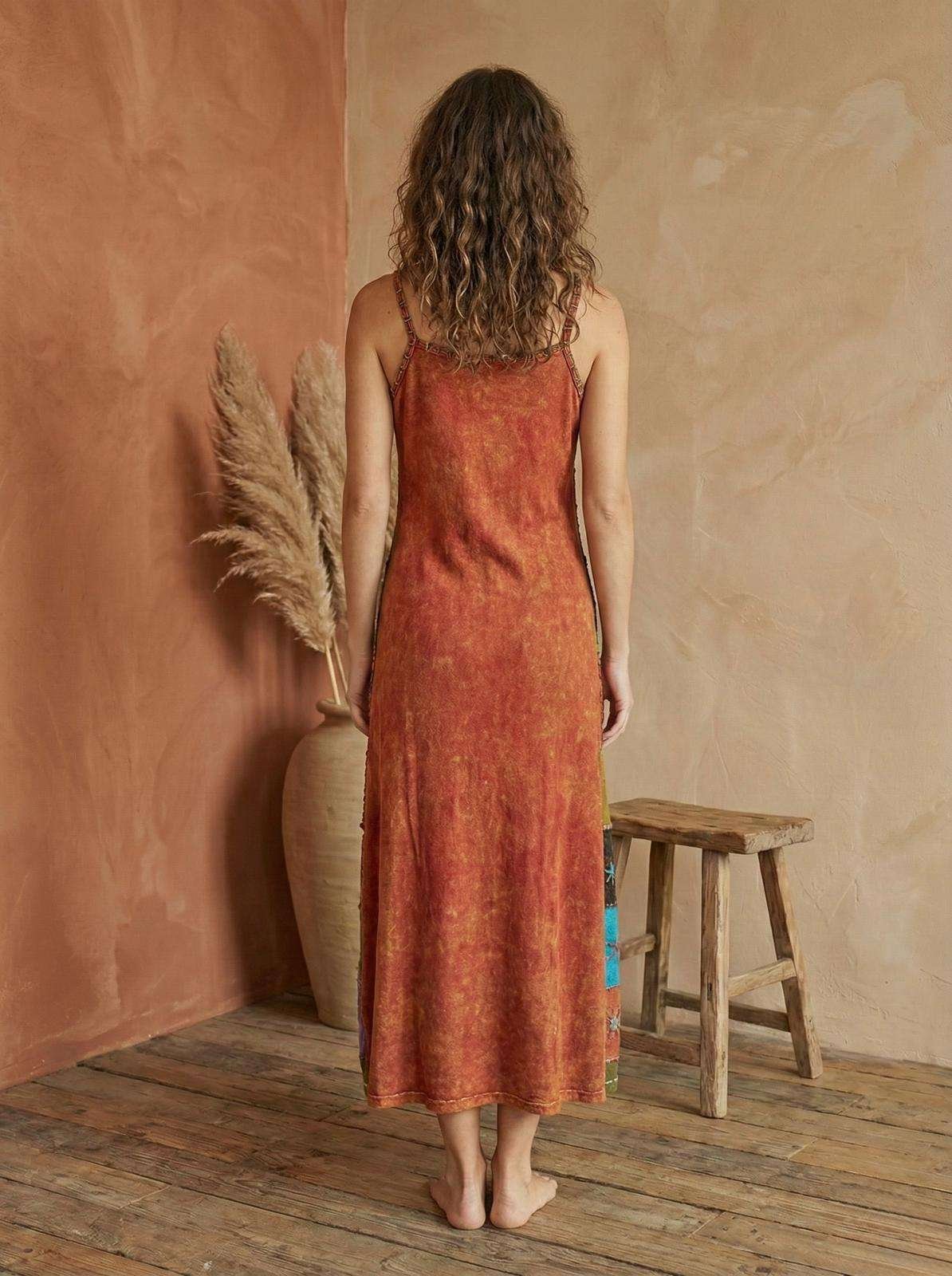 a model wearing retro patchwork dress and posing in earthy background