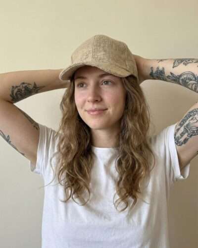 a woman wearing beige hemp cap and posing
