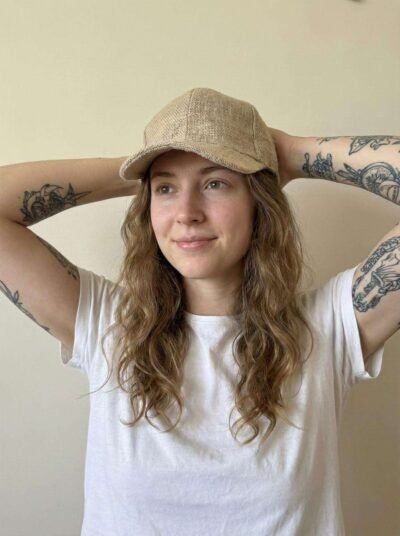 a woman wearing beige hemp cap and posing