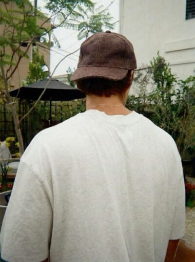 a man wearing brown spreadmaya hemp cap and posing from back