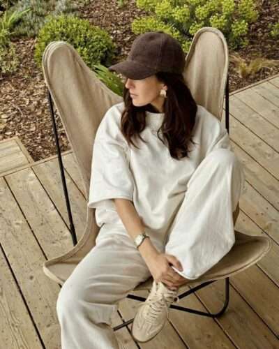a woman wearing hemp hat and posing siting on the chair