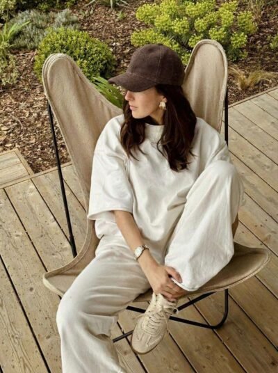 a woman wearing hemp hat and posing siting on the chair