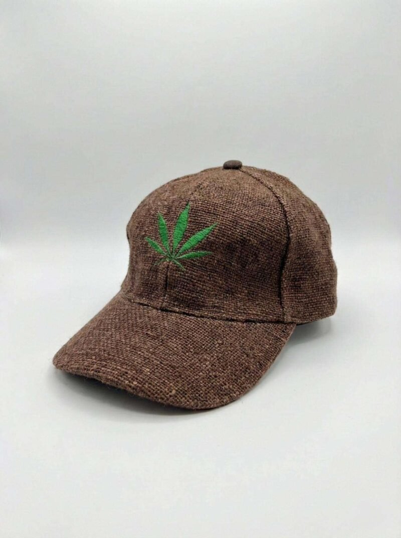 Brown hemp cap with leaf embroidery displayed on a bench