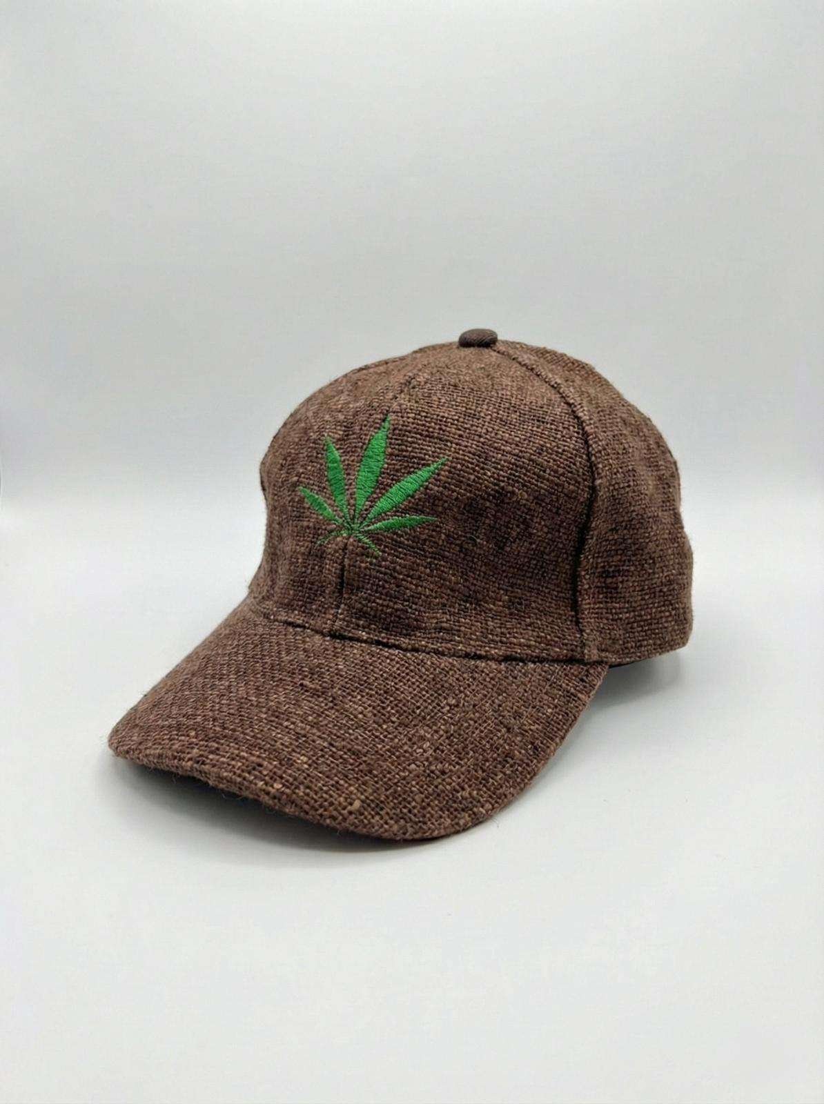 Brown hemp cap with leaf embroidery displayed on a bench