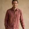 a man wearing full sleeve hemp shirt and smiling looking at the camera