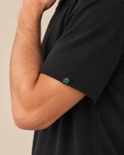 Model wearing a black hemp t-shirt logo deail