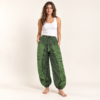 green mushroom printed pants worn by a woman