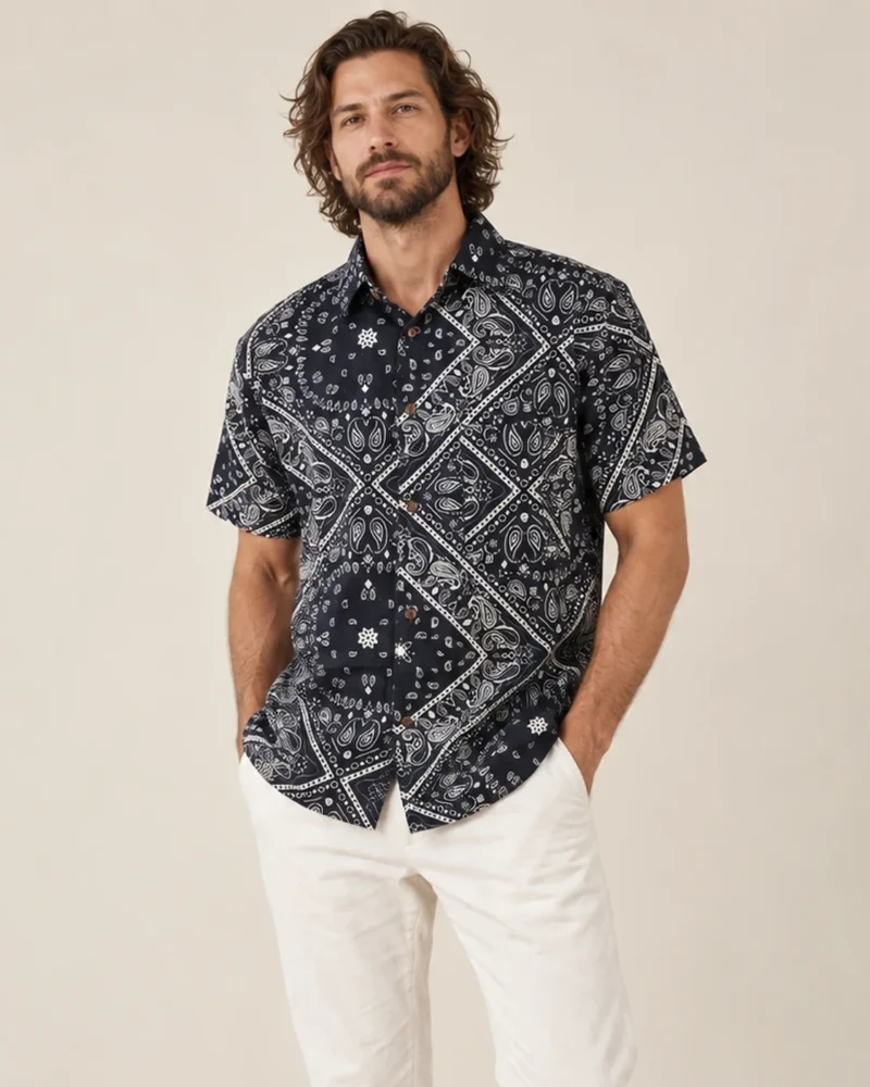 Men’s black mandala hemp short sleeve shirt by Spreadmaya worn by male model, relaxed front pose on beige background.