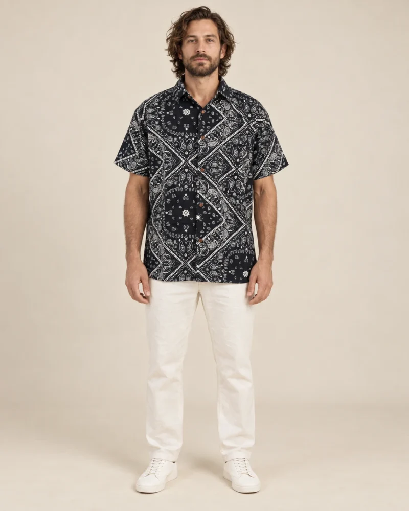 Men’s black mandala hemp short sleeve shirt by Spreadmaya worn by male model, front view on beige background.