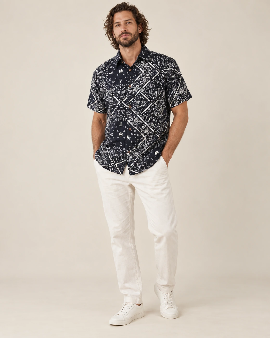 Men’s black mandala hemp short sleeve shirt by Spreadmaya worn by male model, relaxed front pose on beige background.