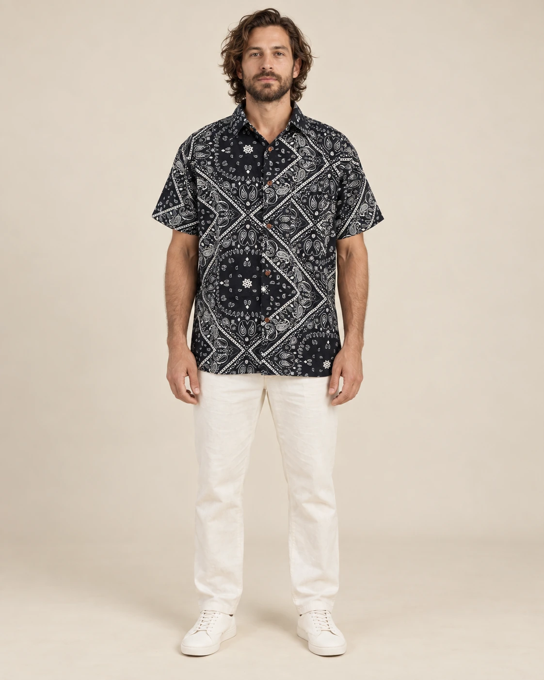 Men’s black mandala hemp short sleeve shirt by Spreadmaya worn by male model, front view on beige background.