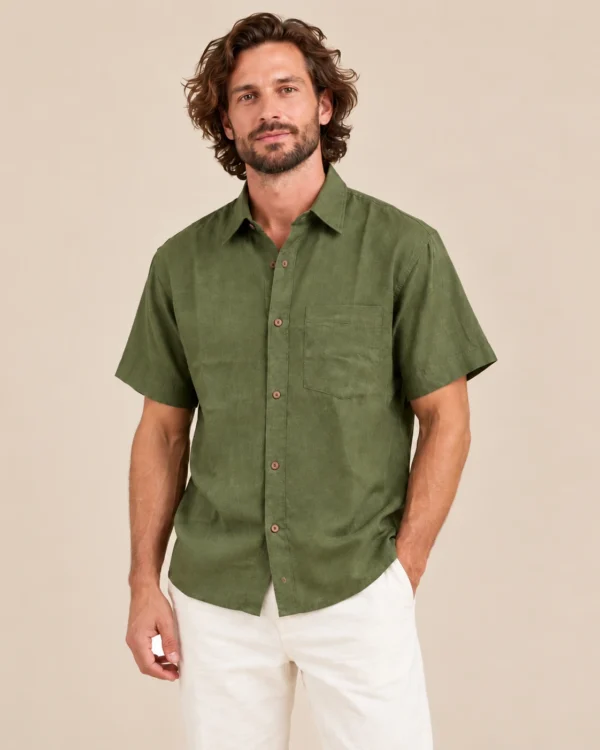 Relaxed view of men’s green short sleeve hemp shirt by Spreadmaya worn by male model on beige background.