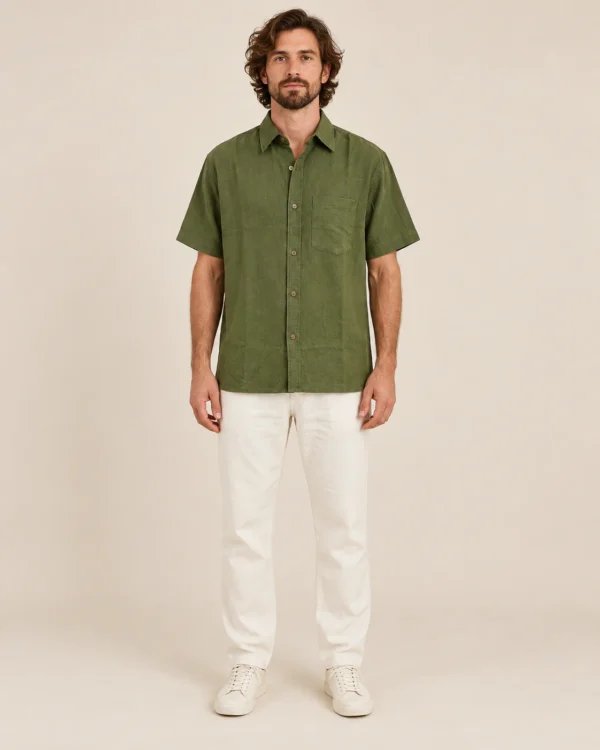 Front view of men’s olive green hemp short sleeve shirt by Spreadmaya worn by male model on beige background.