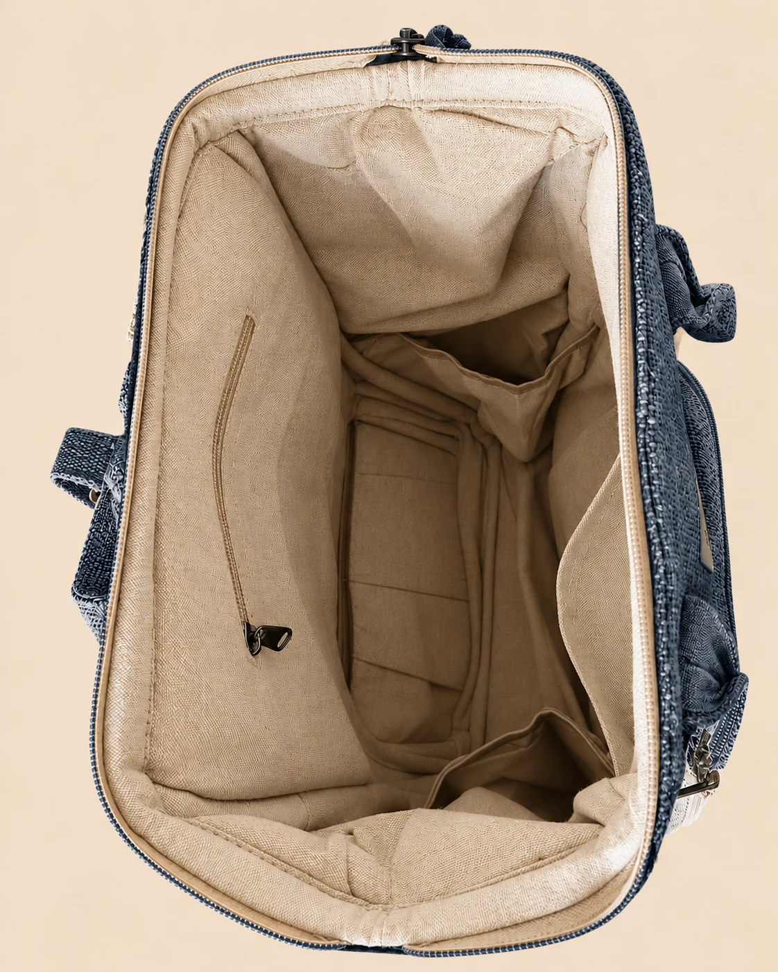 Inside view of SpreadMaya maternity backpack showing multiple organiser pockets for nappies, baby essentials and accessories
