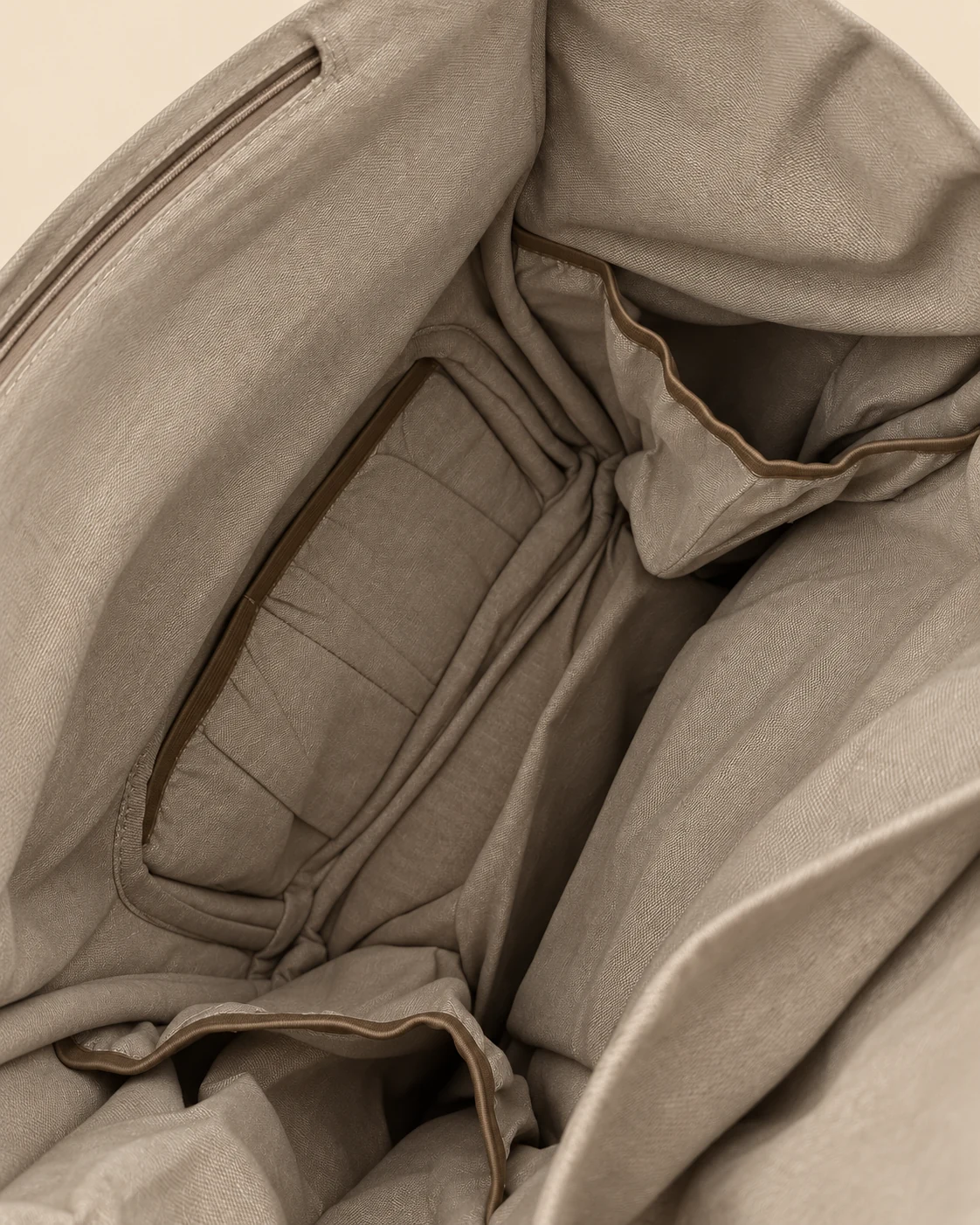 Inside view of SpreadMaya maternity backpack showing multiple organiser pockets for nappies, baby essentials and accessories.