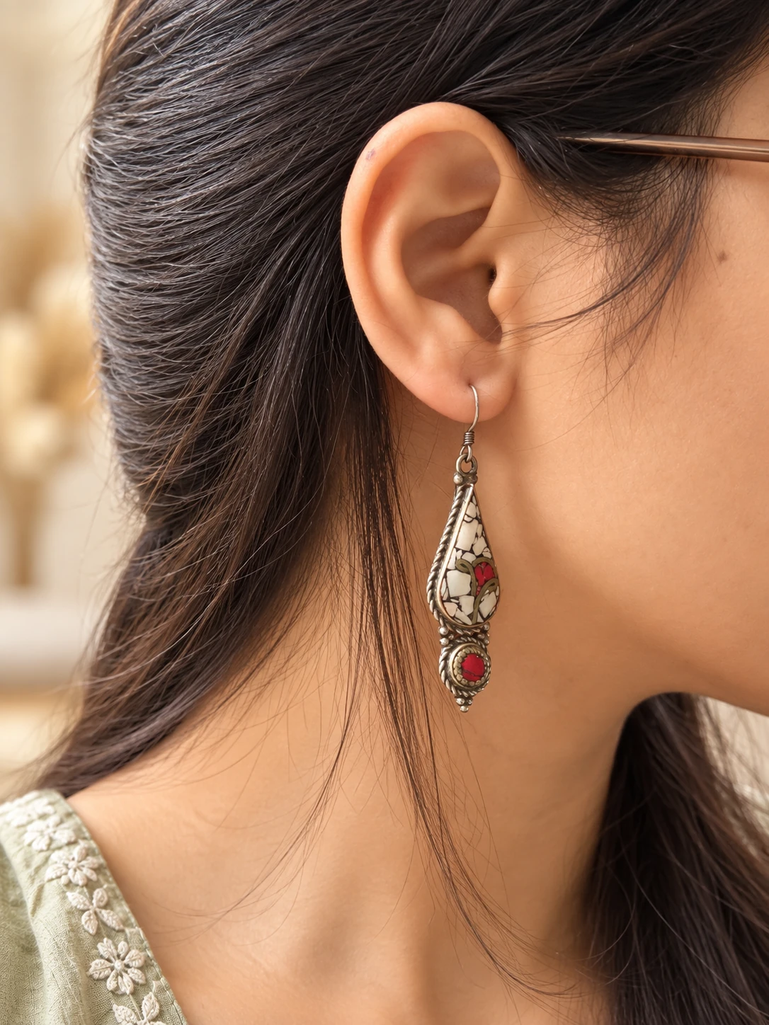 white red mosaic earring worn by woman